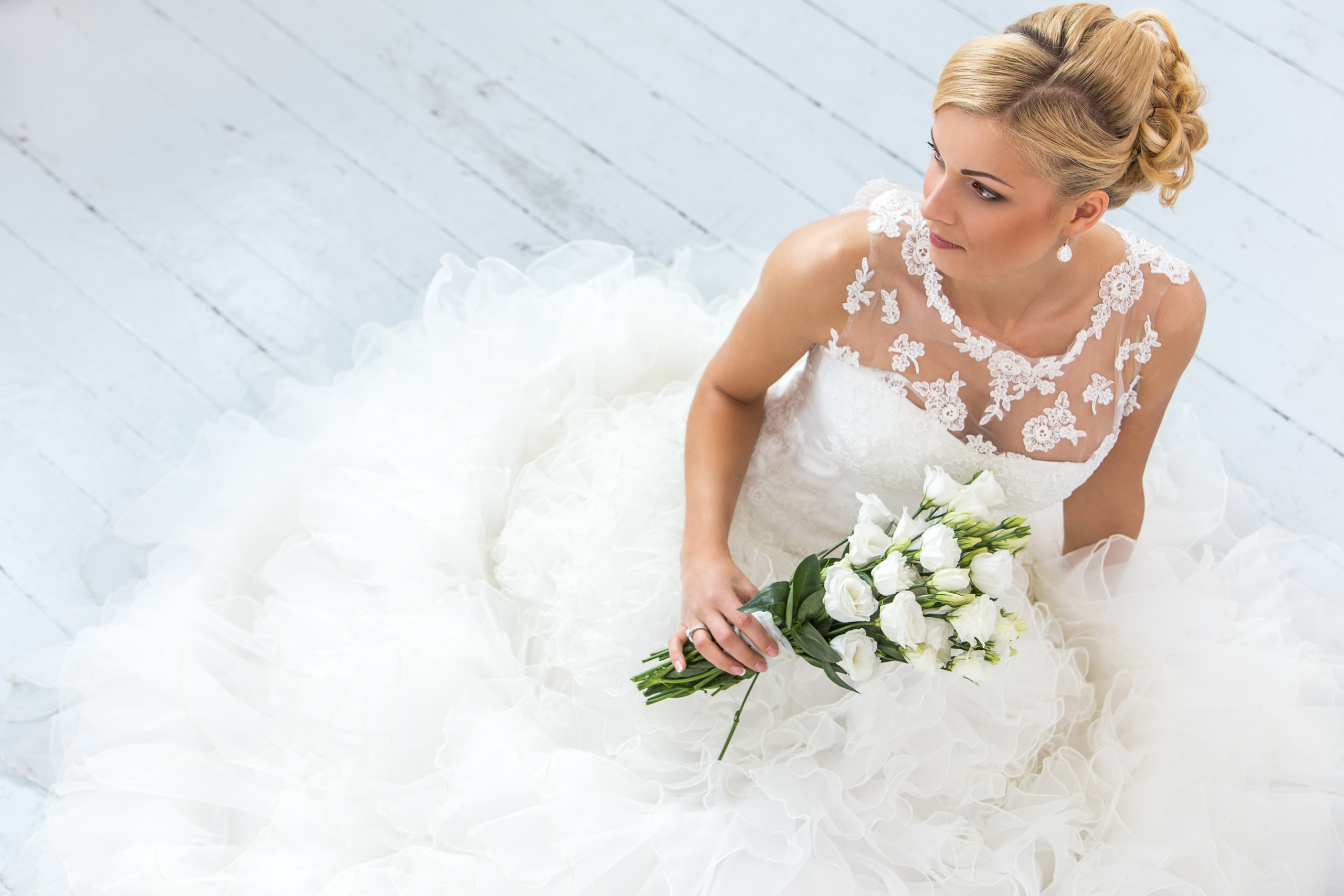 Sposa seduta per terra con bouquet